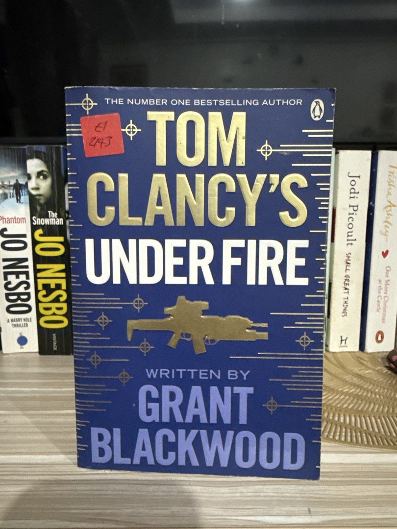 Tom Clancy's Under Fire by Grant Blackwood (Category: Storybooks) located in Pasig City. Submitted by carenem (Listing ID 1463208792, Image 1). Description: - Title: Tom Clancy's Under Fire - Author: Grant Blackwood - Edition: Paperback - Cover: Blue with gold lettering and rifle illustration - Condition: Pages yellowed from age - Genre: Military Thriller - Ideal for: Fans of the genre.
