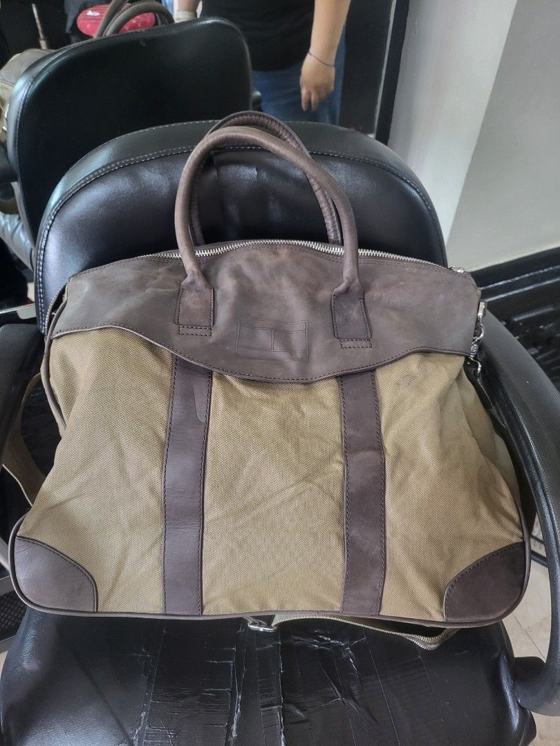 Tommy Hilfiger Canvas & Leather Messenger Bag (Category: Sling Bags) located in Manila. Submitted by milkymitch23 (Listing ID 1463301928, Image 2). Description: - Authentic Tommy Hilfiger messenger bag - Khaki canvas with brown leather accents - Adjustable shoulder strap for comfort - Secure zip closure for the main compartment - Multiple interior pockets for organization - Interior zip pocket for valuables - Ideal for everyday use or travel - No