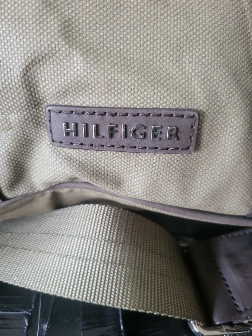 Tommy Hilfiger Canvas & Leather Messenger Bag (Category: Sling Bags) located in Manila. Submitted by milkymitch23 (Listing ID 1463301928, Image 3). Description: - Authentic Tommy Hilfiger messenger bag - Khaki canvas with brown leather accents - Adjustable shoulder strap for comfort - Secure zip closure for the main compartment - Multiple interior pockets for organization - Interior zip pocket for valuables - Ideal for everyday use or travel - No