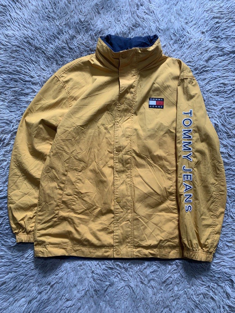 Tommy Jeans Reversible Jacket Yellow/Navy Colorblock (Category: Coats, Jackets and Outerwear) located in Cebu City. Submitted by ninyothrift (Listing ID 1463184446, Image 1). Description: - Reversible Tommy Jeans jacket: Yellow on one side, Navy on the other. - Yellow side features snap button closure and 'Tommy Jeans' text on the sleeve. - Navy side features zipper closure and red/white colorblock panels. - Both sides display the iconic Tommy Je