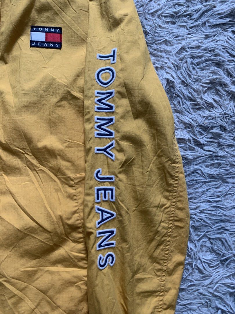 Tommy Jeans Reversible Jacket Yellow/Navy Colorblock (Category: Coats, Jackets and Outerwear) located in Cebu City. Submitted by ninyothrift (Listing ID 1463184446, Image 3). Description: - Reversible Tommy Jeans jacket: Yellow on one side, Navy on the other. - Yellow side features snap button closure and 'Tommy Jeans' text on the sleeve. - Navy side features zipper closure and red/white colorblock panels. - Both sides display the iconic Tommy Je