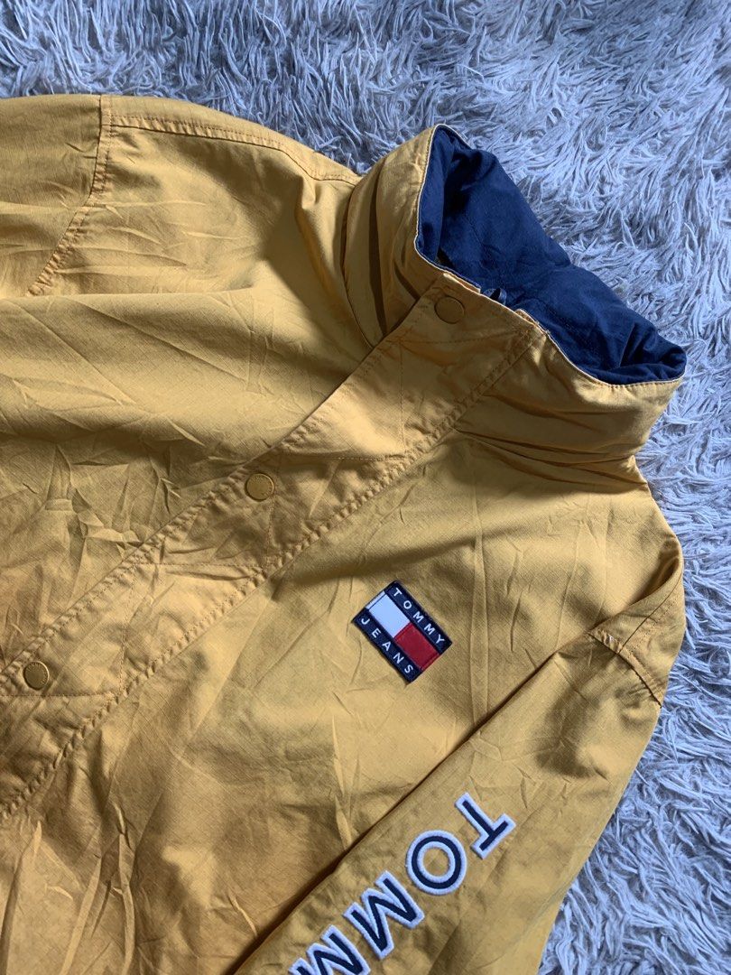 Tommy Jeans Reversible Jacket Yellow/Navy Colorblock (Category: Coats, Jackets and Outerwear) located in Cebu City. Submitted by ninyothrift (Listing ID 1463184446, Image 2). Description: - Reversible Tommy Jeans jacket: Yellow on one side, Navy on the other. - Yellow side features snap button closure and 'Tommy Jeans' text on the sleeve. - Navy side features zipper closure and red/white colorblock panels. - Both sides display the iconic Tommy Je