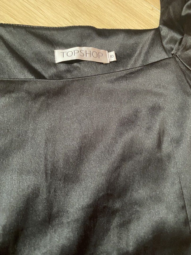 Topshop Black Satin Square Neck Top (Category: Blouses) located in Tanauan. Submitted by rie098 (Listing ID 1463277343, Image 3). Description: - Topshop black satin top - Size: Approximately 10 - Neckline: Square - Sleeves: Short flutter sleeves - Fit: Fitted bodice with darting - Style: Perfect for dressing up or down.