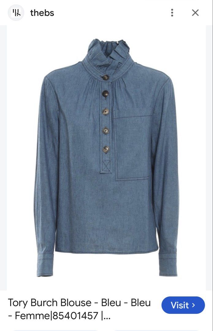 Tory Burch Chambray Ruffle Neck Blouse (Category: Blouses) located in Santiago. Submitted by yrellagnoihsaf (Listing ID 1463142371, Image 3). Description: - Brand: Tory Burch - Color: Blue Chambray - Size: 4 - Features: Ruffled high neck, button-up front, long sleeves with button cuffs, chest pocket - Origin: Made in China.