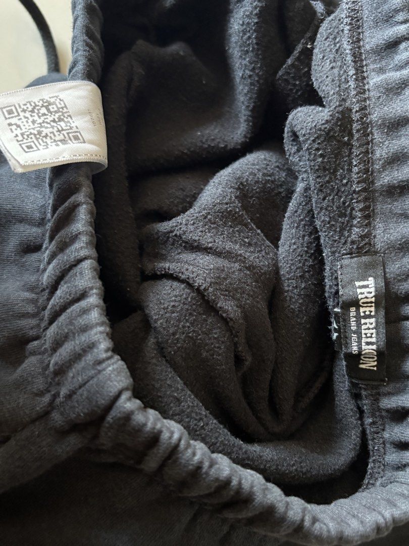 True Religion Black Sweatpants Joggers (Category: Joggers) located in Quezon City. Submitted by ginoongpablo (Listing ID 1463170335, Image 3). Description: - Black True Religion sweatpants - Elastic waistband with drawstring - Classic True Religion logo on back pocket - Large logo graphic on left leg - Comfortable and stylish for everyday wear - Ideal for lounging or casual outings.