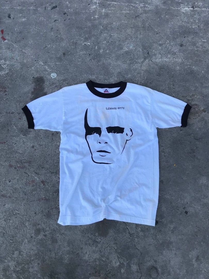 Tubeway Army Ringer T-Shirt (Category: Tshirts & Polo Shirts ) located in Manila. Submitted by youngstorm-c604 (Listing ID 1463168057, Image 2). Description: - White ringer t-shirt with black trim - Features Tubeway Army logo and face graphic on front - Made in Mexico - Size: Medium - Condition: Some faint yellowing/stains visible on fabric.