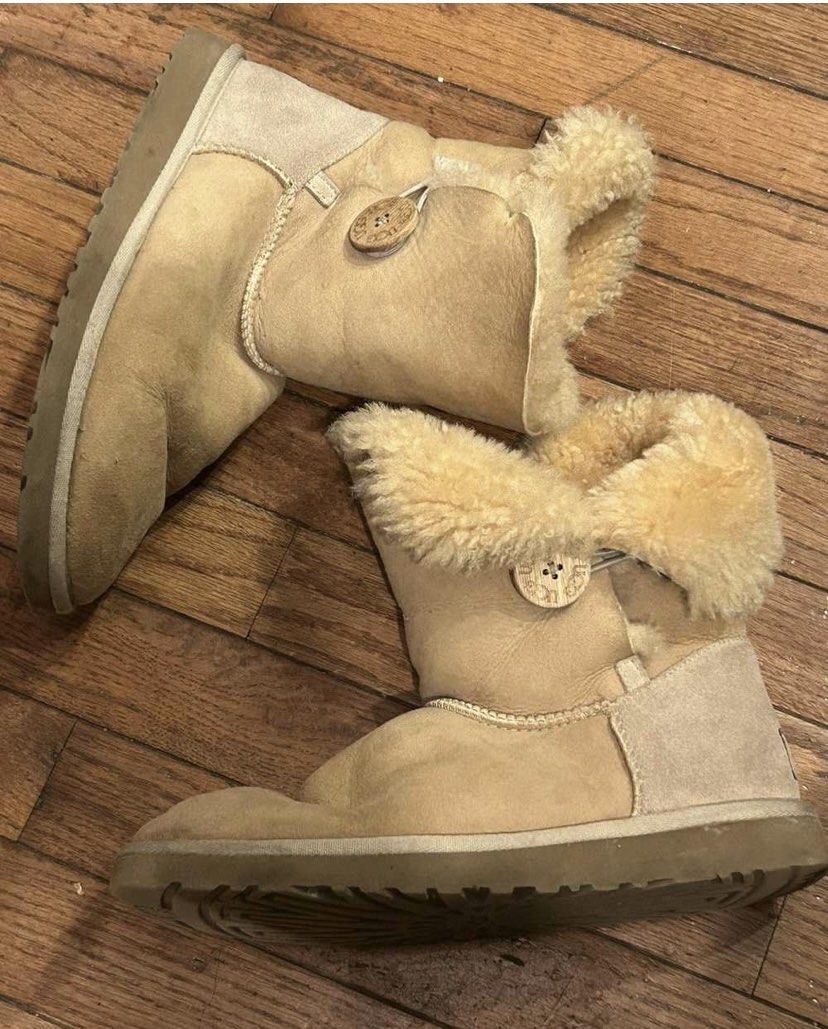 UGG Australia Bailey Button Boots (Category: Boots) located in Baguio. Submitted by workwear2600 (Listing ID 1463203186, Image 1). Description: - Classic UGG Bailey Button boots - Color: Tan/Beige - Size: Women's 5 (W5) - Features warm sheepskin lining for ultimate comfort - Signature UGG Australia sole - Convenient side button closure - Ideal for everyday casual wear.
