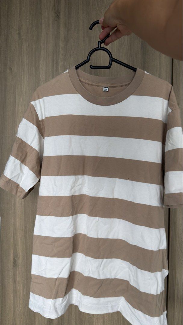 Uniqlo Striped T-Shirt (Category: Tshirts & Polo Shirts ) located in Manila. Submitted by jmbb00.03 (Listing ID 1463136342, Image 1). Description: - Classic brown and white striped t-shirt from Uniqlo - Short sleeves and crew neck design - Made from comfortable cotton material - Ideal for everyday casual wear - Easily pairs with jeans or shorts - A versatile wardrobe staple.