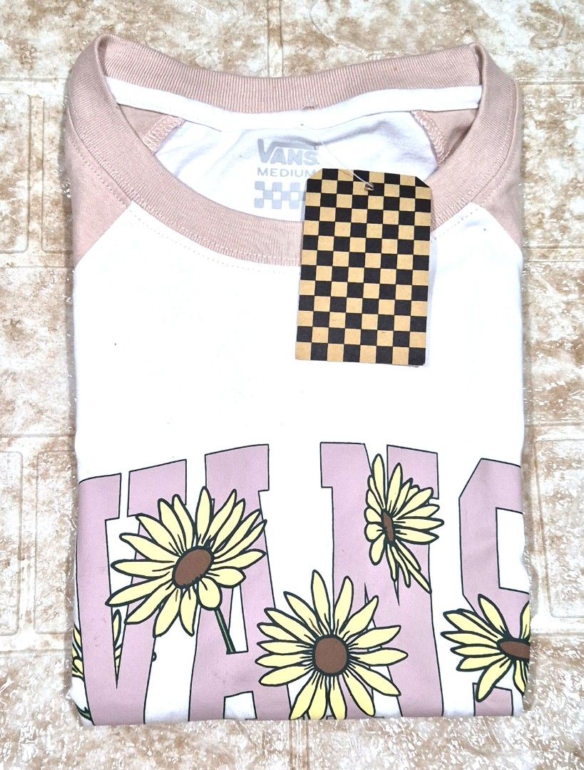 Vans Daisy T-shirt - Size Medium (Category: Tshirts & Polo Shirts ) located in Antipolo. Submitted by saribymonica (Listing ID 1463247058, Image 1). Description: - Cute Vans t-shirt - Size: Medium - White body with pink raglan sleeves - Features a daisy graphic and Vans logo - Perfect for casual wear - Fun addition to your collection *Stored in the closet for a long time, so you may want to wash it again before use. 😊 📌 Please note: Reasonable 
