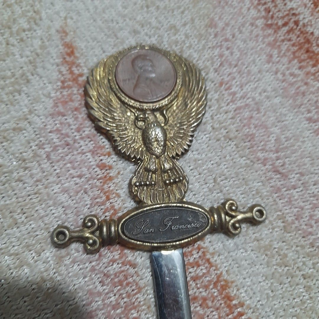 Vintage Letter Opener (Category: Vintage Collectibles) located in Bocaue. Submitted by marajapansurplus (Listing ID 1463243784, Image 3). Description: - Vintage letter opener with detailed eagle design on handle. - Features an inset coin on the handle. - 'San Francisco' is inscribed on the handle. - Blade is stainless steel and marked. - Perfect for desk decor or a collector's item. - Shows some signs of age, adding to its vintage charm..