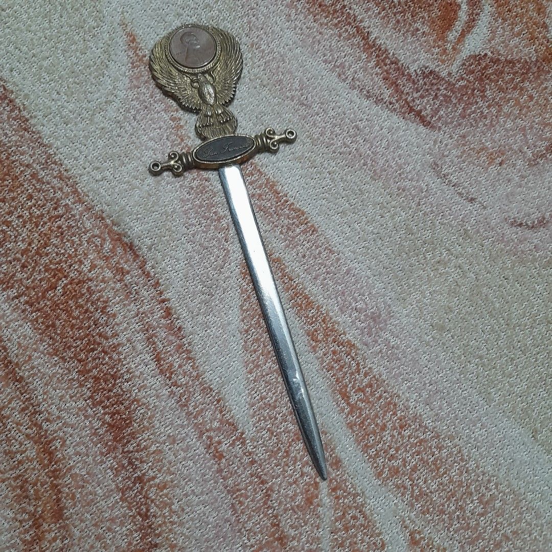 Vintage Letter Opener (Category: Vintage Collectibles) located in Bocaue. Submitted by marajapansurplus (Listing ID 1463243784, Image 2). Description: - Vintage letter opener with detailed eagle design on handle. - Features an inset coin on the handle. - 'San Francisco' is inscribed on the handle. - Blade is stainless steel and marked. - Perfect for desk decor or a collector's item. - Shows some signs of age, adding to its vintage charm..