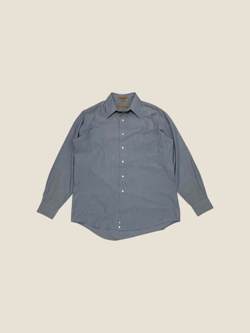 Vintage Milano Uomo Slate Blue Button-Down Shirt (Category: Formal Shirts) located in Santa Rosa. Submitted by revive.n.thrive (Listing ID 1463304901, Image 1). Description: A minimal essential tailored for an effortless preppy look and quiet luxury aesthetic. Rendered in a muted slate blue / chambray-style tone, this piece features a sharp pointed spread collar, clean front placket with pearl white buttons, and a single left chest pocket. Cut fr