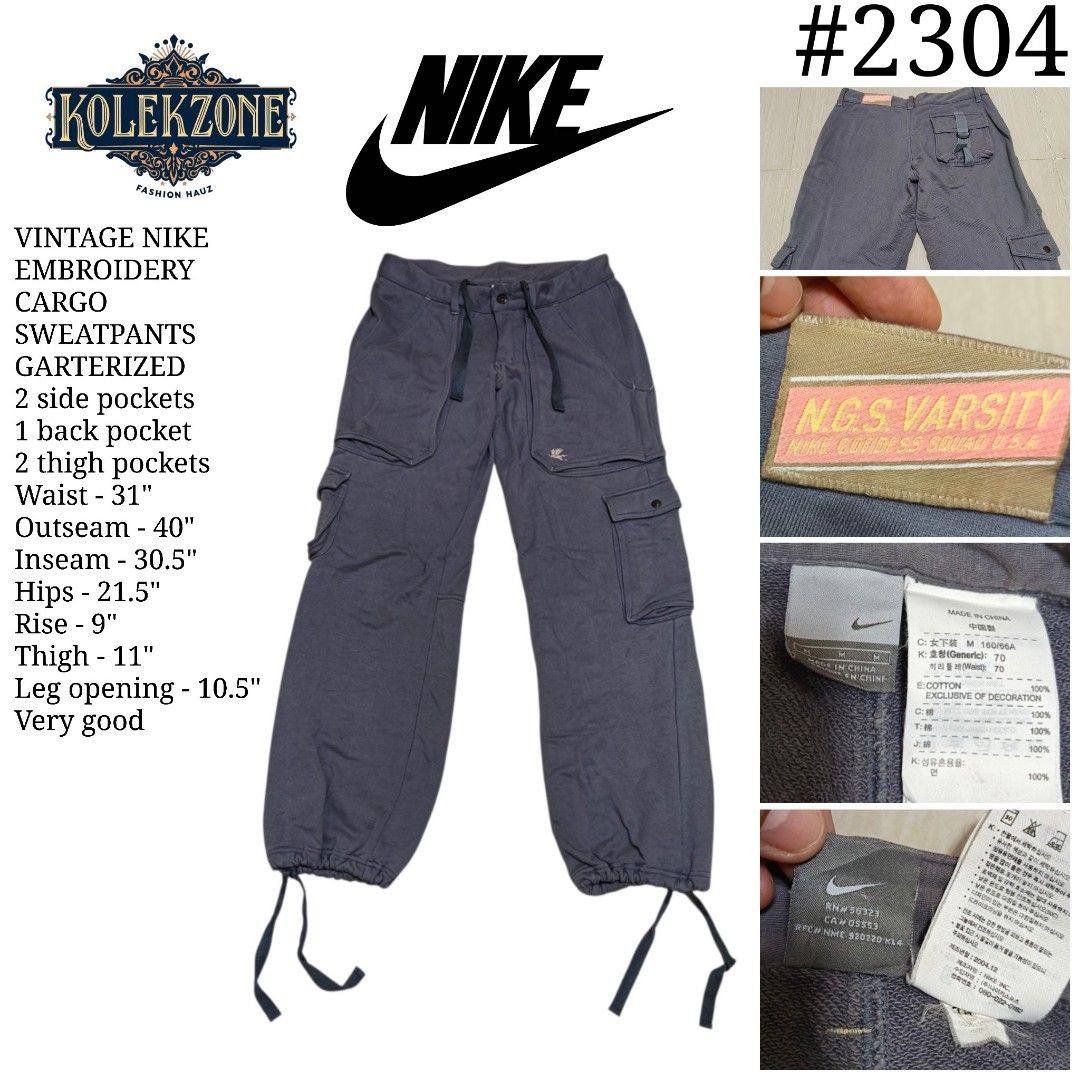 Vintage Nike Embroidery Cargo Sweatpants (Category: Joggers) located in Nasugbu. Submitted by staffpicks1515 (Listing ID 1463244142, Image 1). Description: - Vintage Nike cargo sweatpants - Garterized waist with drawstring - Multiple pockets: 2 side, 1 back, 2 thigh - Waist: 31 inches - Outseam: 40 inches - Inseam: 30.5 inches - Hips: 21.5 inches - Rise: 9 inches - Thigh: 11 inches - Leg opening: 10.5 inches.
