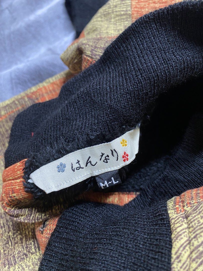 Vintage-style long-sleeve cardigan / knit pullover (Category: Coats, Jackets and Outerwear) located in General Trias. Submitted by kevinthriftshop (Listing ID 1463258316, Image 2). Description: Brand: Japanese brand 「はんなり」 (Hannari) based on the visible label Size: M–L (as indicated on the size tag) Color: Olive/mustard green base with orange and dark brown accents Pattern: Retro checkered / plaid-inspired geometric pattern.