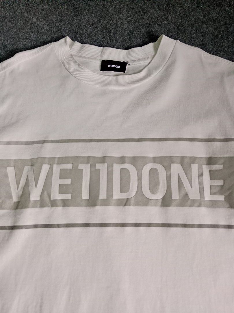 WE11DONE White Graphic T-Shirt Size S (Category: Tshirts & Polo Shirts ) located in Alburquerque. Submitted by romnickhatosa (Listing ID 1463176787, Image 2). Description: - Brand: WE11DONE - Color: White - Design: Grey graphic stripe across chest with brand name - Size: S - Material: 100% Cotton - Origin: Made in Korea - Style: Great for casual wear.
