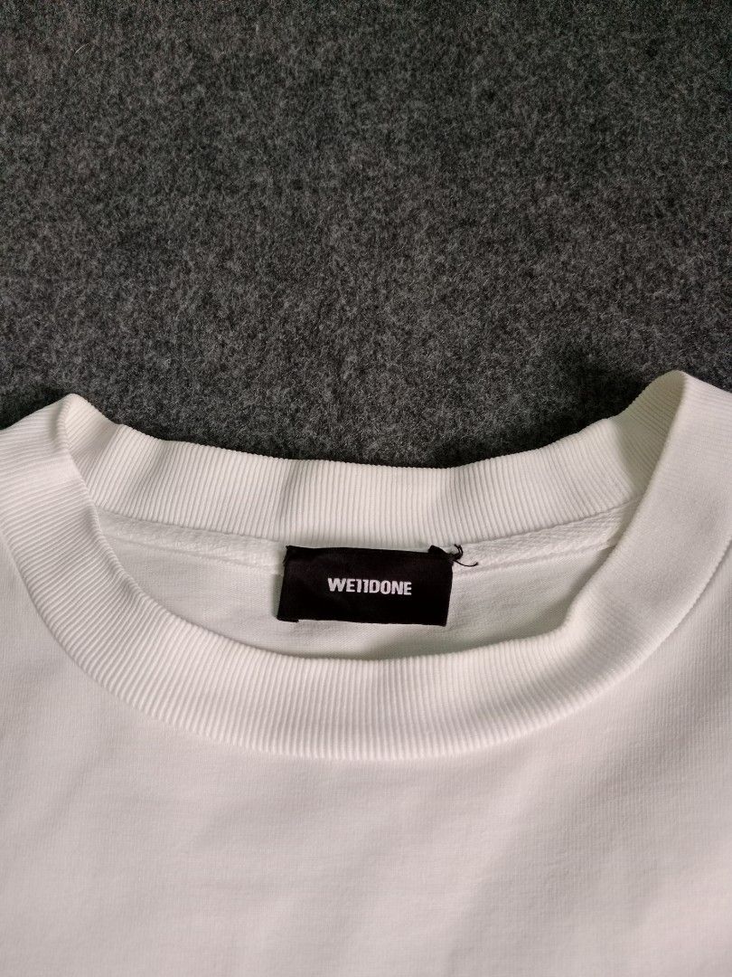 WE11DONE White Graphic T-Shirt Size S (Category: Tshirts & Polo Shirts ) located in Alburquerque. Submitted by romnickhatosa (Listing ID 1463176787, Image 3). Description: - Brand: WE11DONE - Color: White - Design: Grey graphic stripe across chest with brand name - Size: S - Material: 100% Cotton - Origin: Made in Korea - Style: Great for casual wear.