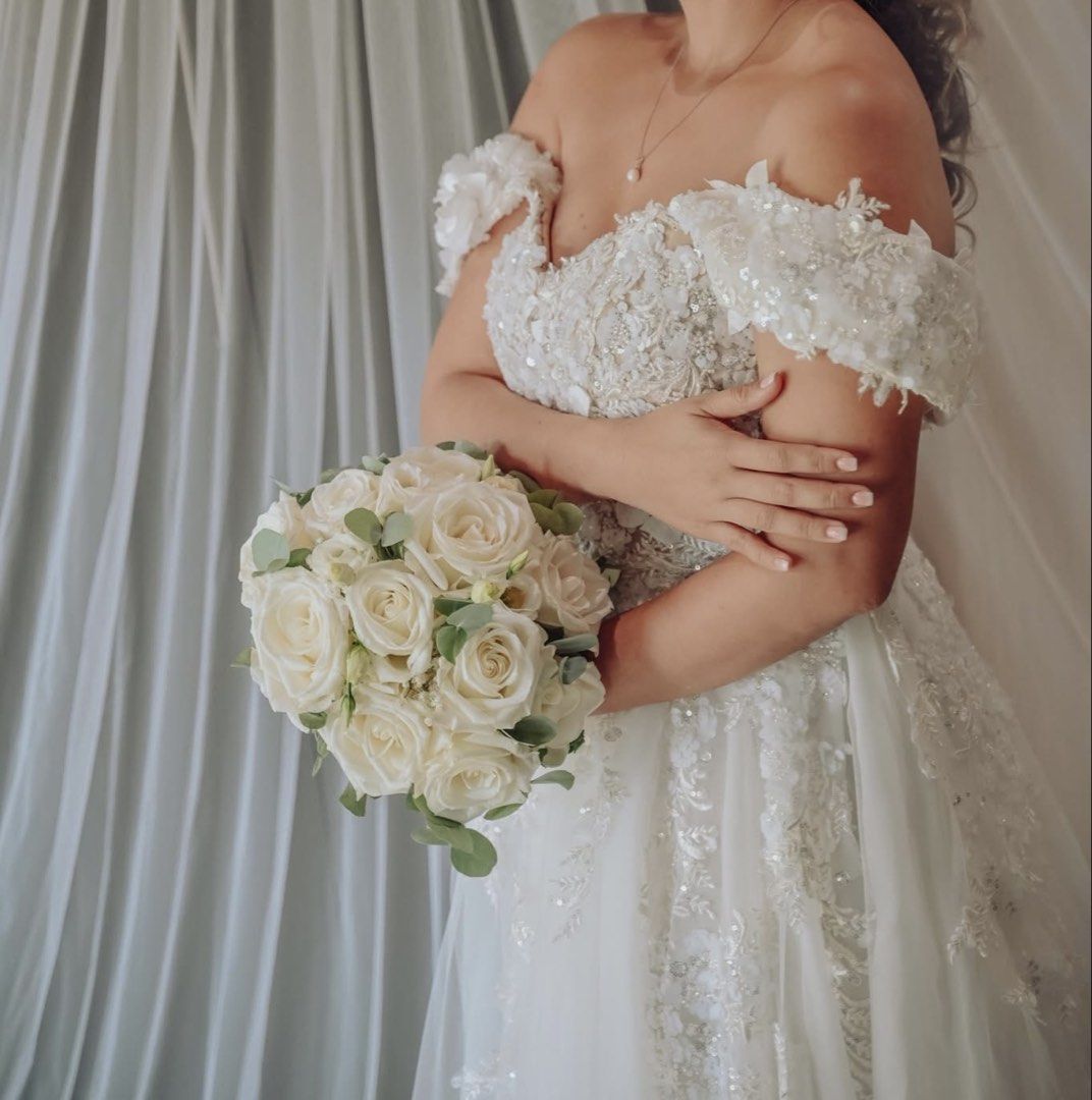 Wedding gown (Category: Evening dresses & gowns) located in Cebu City. Submitted by prelovedbymecebu (Listing ID 1463322276, Image 2). Description: Made by Yoko Sato Cebu Custom off-shoulder wedding gown featuring a sweetheart neckline, exquisite 3D floral appliqués and intricate beadwork across the bodice, and a graceful layered tulle skirt. Measurements: Please check photo Not yet dry cleaned used only for 9hours Selling for 20k Negotiable Loc 