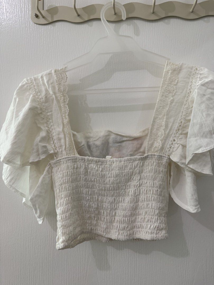 White Embroidered Square Neck Crop Top (Category: Sleeveless) located in Quezon City. Submitted by graceavm. (Listing ID 1463136412, Image 3). Description: - white crop top w/ floral embroidery on the front - flattering square neckline w/ flutter sleeves - Comfortable smocked waist for a perfect fit - fits S-M.