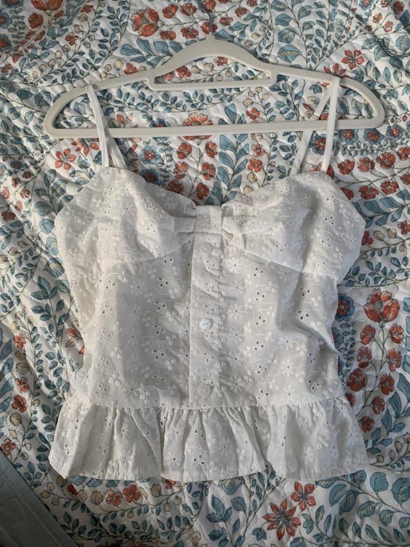 White Eyelet Peplum Top with Button Detail (Category: Sleeveless) located in Manila. Submitted by curatedclassics (Listing ID 1463214452, Image 1). Description: never used fits small, hugs waist area has zipper on the side.
