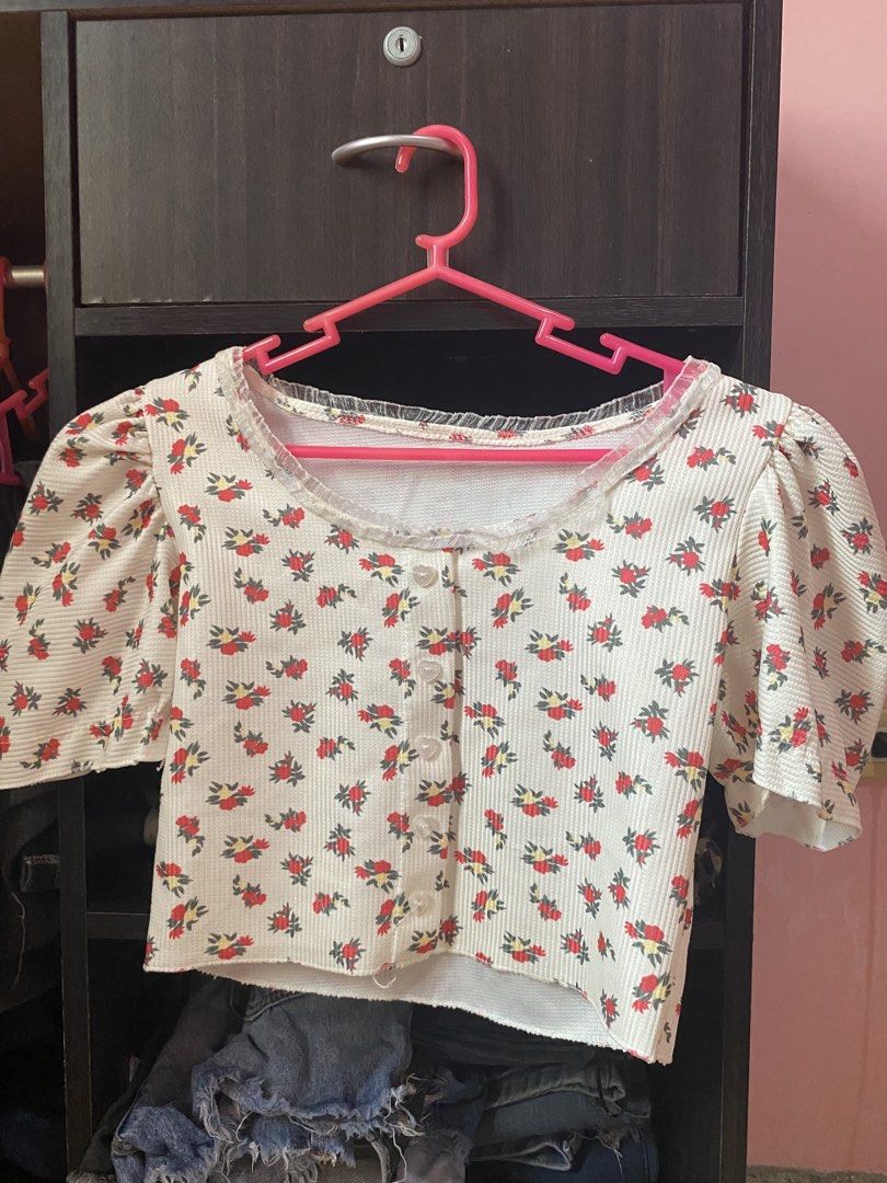 White Floral Puff Sleeve Button Up Crop Top (Category: Blouses) located in Tanauan. Submitted by rie098 (Listing ID 1463276710, Image 2). Description: - White crop top with charming red floral print - Features stylish puff sleeves - Convenient button-up front closure - Delicate lace trim around the neckline - Textured fabric for a unique feel - Versatile for casual outings or dressing up.