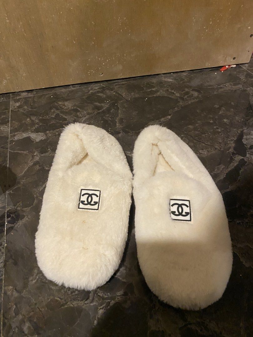 White Fuzzy Slippers with Chanel Logo (Category: Slippers and slides) located in Manila. Submitted by hanzlopez (Listing ID 1463273258, Image 2). Description: - Super comfy white fuzzy slippers - Iconic Chanel logo on the side - Cute lucky cat design on the sole - Size 39 - Perfect for lounging at home - Made with soft and warm material.