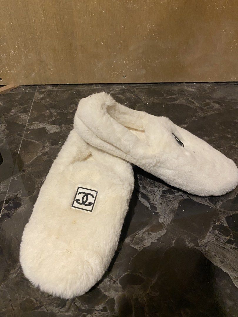 White Fuzzy Slippers with Chanel Logo (Category: Slippers and slides) located in Manila. Submitted by hanzlopez (Listing ID 1463273258, Image 1). Description: - Super comfy white fuzzy slippers - Iconic Chanel logo on the side - Cute lucky cat design on the sole - Size 39 - Perfect for lounging at home - Made with soft and warm material.