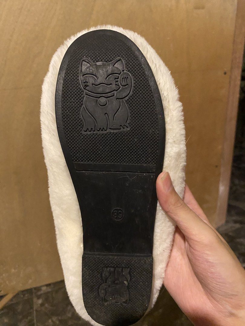White Fuzzy Slippers with Chanel Logo (Category: Slippers and slides) located in Manila. Submitted by hanzlopez (Listing ID 1463273258, Image 3). Description: - Super comfy white fuzzy slippers - Iconic Chanel logo on the side - Cute lucky cat design on the sole - Size 39 - Perfect for lounging at home - Made with soft and warm material.