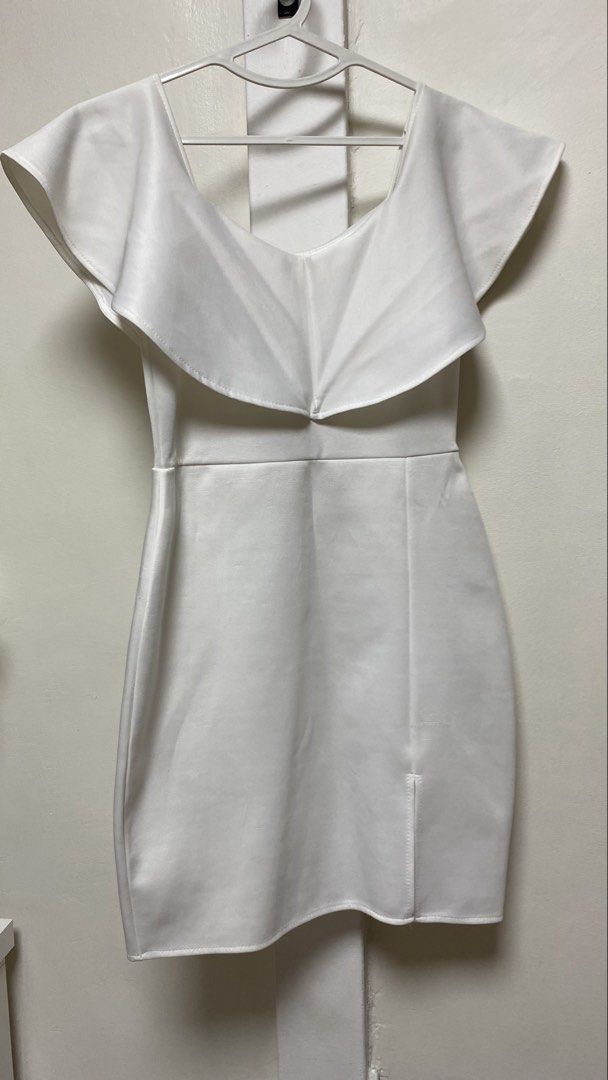 White Off-Shoulder Ruffle Dress (Category: Dresses) located in Manila. Submitted by gelmagtira87162 (Listing ID 1463202351, Image 1). Description: - Chic white off-shoulder dress - Features a stylish ruffled overlay - Flattering fitted silhouette - Subtle side slit for ease of movement - Made from a smooth, structured fabric - Ideal for parties, events, or special occasions.