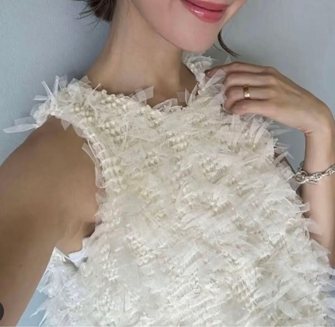 White Textured Sleeveless Halter Neck Top (Category: Sleeveless) located in Manila. Submitted by prettyme31 (Listing ID 1463322382, Image 2). Description: - White sleeveless top - Unique textured/fringe-like overlay - Halter neck style - Zip closure at the back - Versatile: dress up or down - Perfect for summer evenings or a night out.