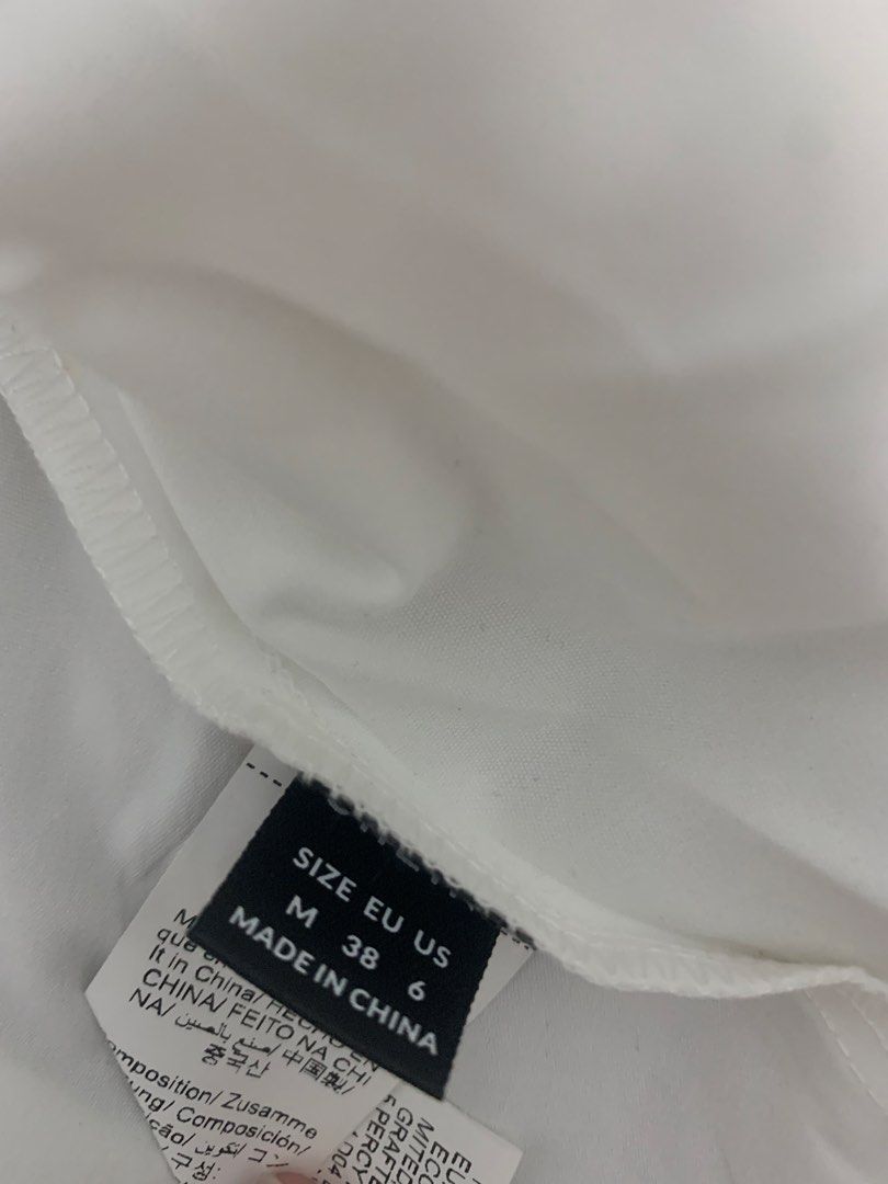 White Top with Ruffle Sleeves (Category: Blouses) located in Pasig City. Submitted by elliebabes_ (Listing ID 1463234860, Image 2). Description: - White top - Cute ruffle sleeves - Tie detail at the back - Lace trim along hem and sleeves - Size M.