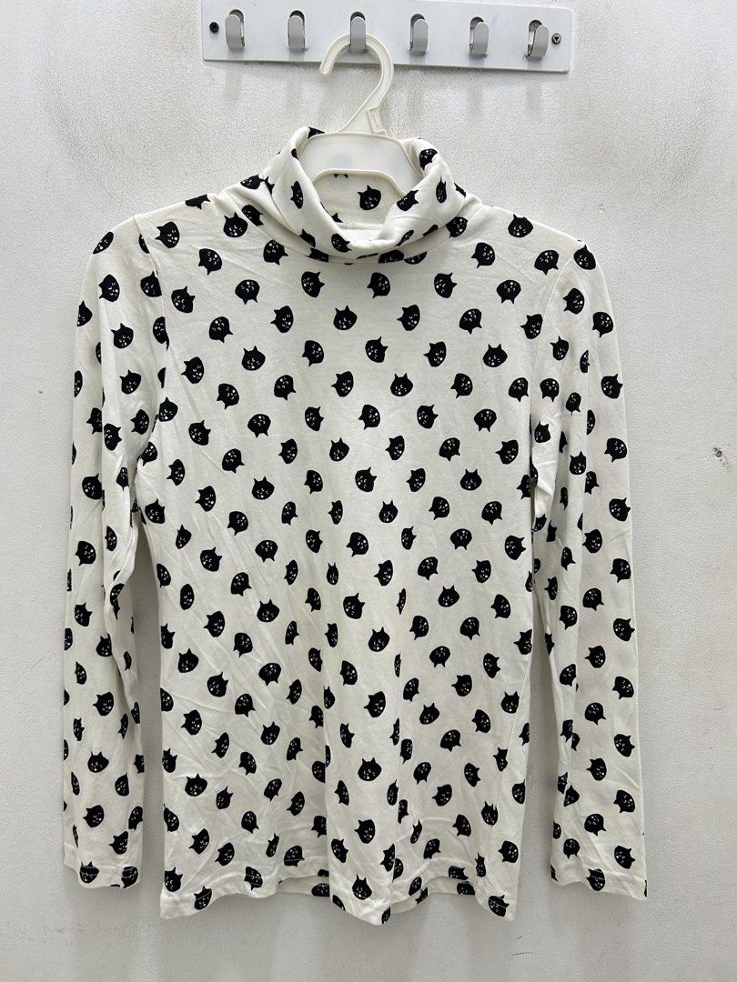 White Turtleneck Top with Black Cat Print (Category: Sleeveless) located in Lucena. Submitted by riyizthriftz (Listing ID 1463273787, Image 1). Description: - White long-sleeved turtleneck top - Adorable all-over black cat print - Soft and stretchy fabric for comfort - Versatile: great for layering or as a standalone piece - Easy to pair with jeans, skirts, and other bottoms - A fun and playful addition to any wardrobe.