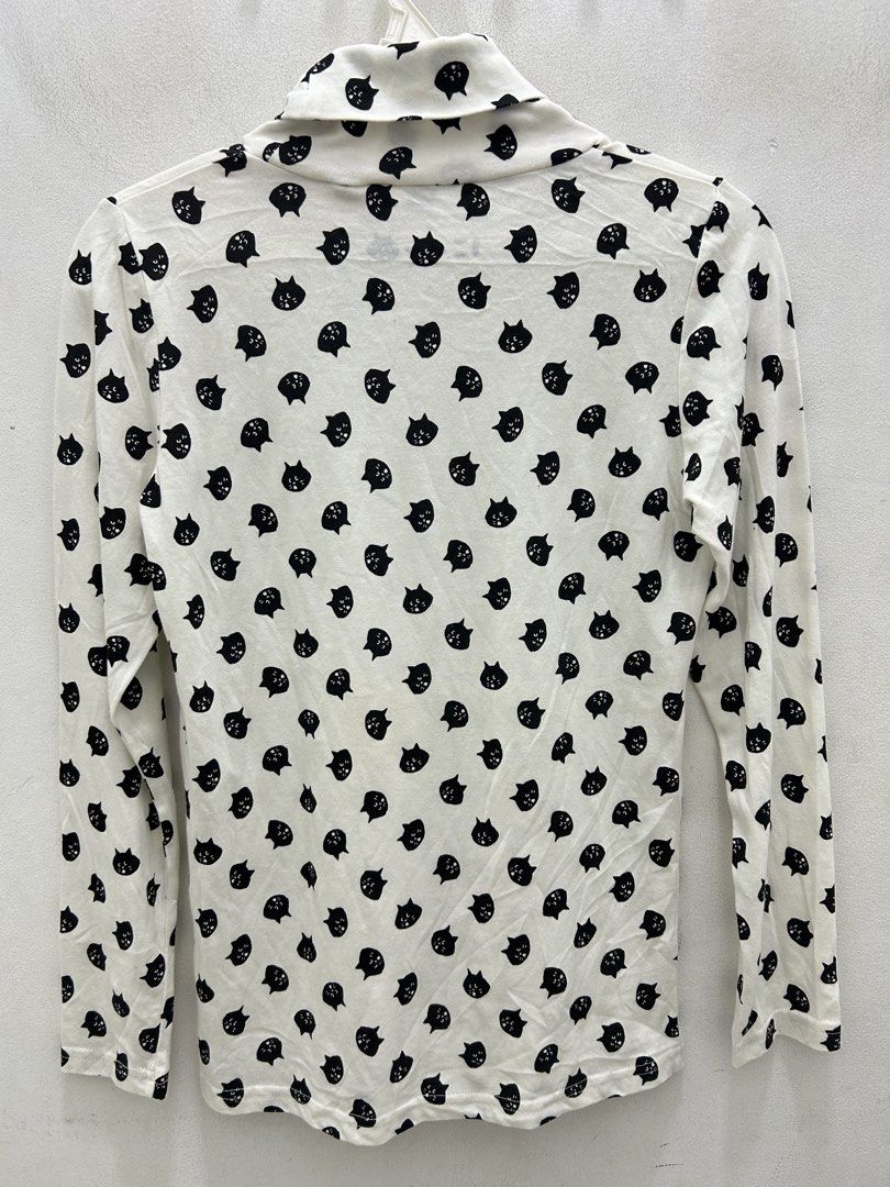White Turtleneck Top with Black Cat Print (Category: Sleeveless) located in Lucena. Submitted by riyizthriftz (Listing ID 1463273787, Image 2). Description: - White long-sleeved turtleneck top - Adorable all-over black cat print - Soft and stretchy fabric for comfort - Versatile: great for layering or as a standalone piece - Easy to pair with jeans, skirts, and other bottoms - A fun and playful addition to any wardrobe.