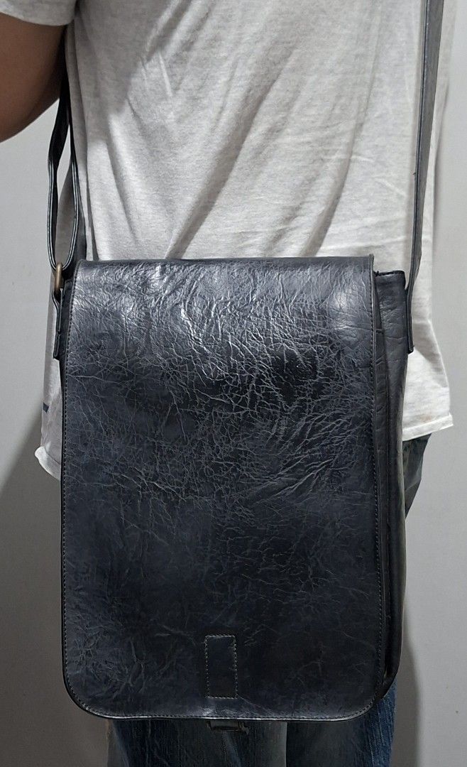 WHY? NOT Vegan Leather Messenger Bag (Category: Luxury Bags & Wallets) located in Quezon City. Submitted by moonthrifting (Listing ID 1463265680, Image 3). Description: - Black messenger bag from WHY? NOT. - Vegan leather with a textured finish. - Adjustable strap for comfortable carrying. - Secure flap closure. - Ideal for everyday use with ample interior space. Length 9.5" Height 12" Width 2.5".