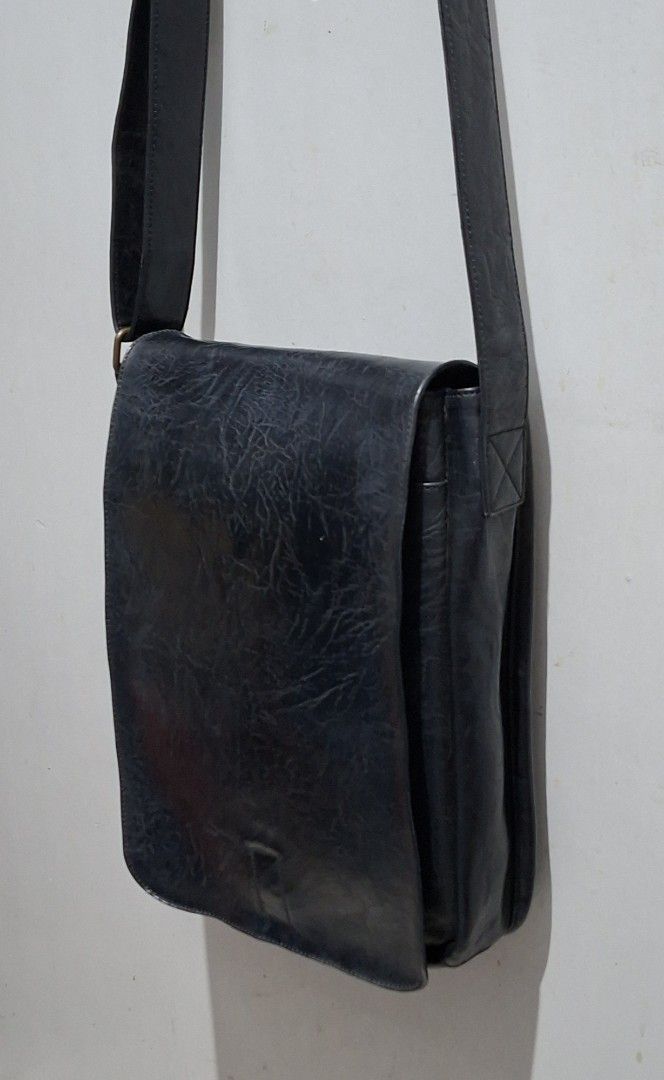 WHY? NOT Vegan Leather Messenger Bag (Category: Luxury Bags & Wallets) located in Quezon City. Submitted by moonthrifting (Listing ID 1463265680, Image 2). Description: - Black messenger bag from WHY? NOT. - Vegan leather with a textured finish. - Adjustable strap for comfortable carrying. - Secure flap closure. - Ideal for everyday use with ample interior space. Length 9.5" Height 12" Width 2.5".