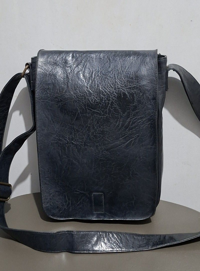 WHY? NOT Vegan Leather Messenger Bag (Category: Luxury Bags & Wallets) located in Quezon City. Submitted by moonthrifting (Listing ID 1463265680, Image 1). Description: - Black messenger bag from WHY? NOT. - Vegan leather with a textured finish. - Adjustable strap for comfortable carrying. - Secure flap closure. - Ideal for everyday use with ample interior space. Length 9.5" Height 12" Width 2.5".