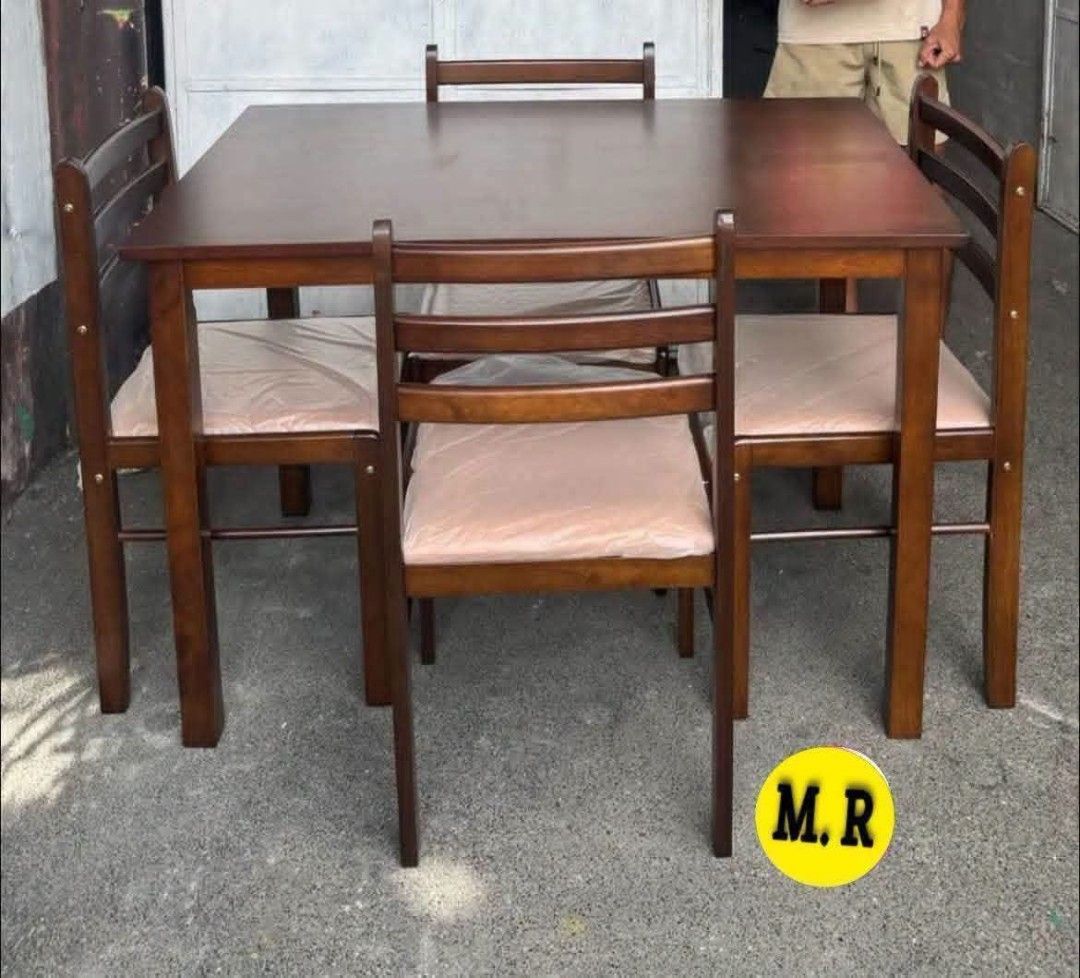 Wooden Dining Table and Chairs Set (Category: Tables & Sets) located in Quezon City. Submitted by marecel146 (Listing ID 1463119521, Image 1). Description: - Wooden dining set - Includes 1 table and 4 chairs - Chairs feature cushioned seats, still in original plastic wrap - Table has a dark wood finish - Ideal for small to medium dining areas - Simple assembly required - Pick up only.