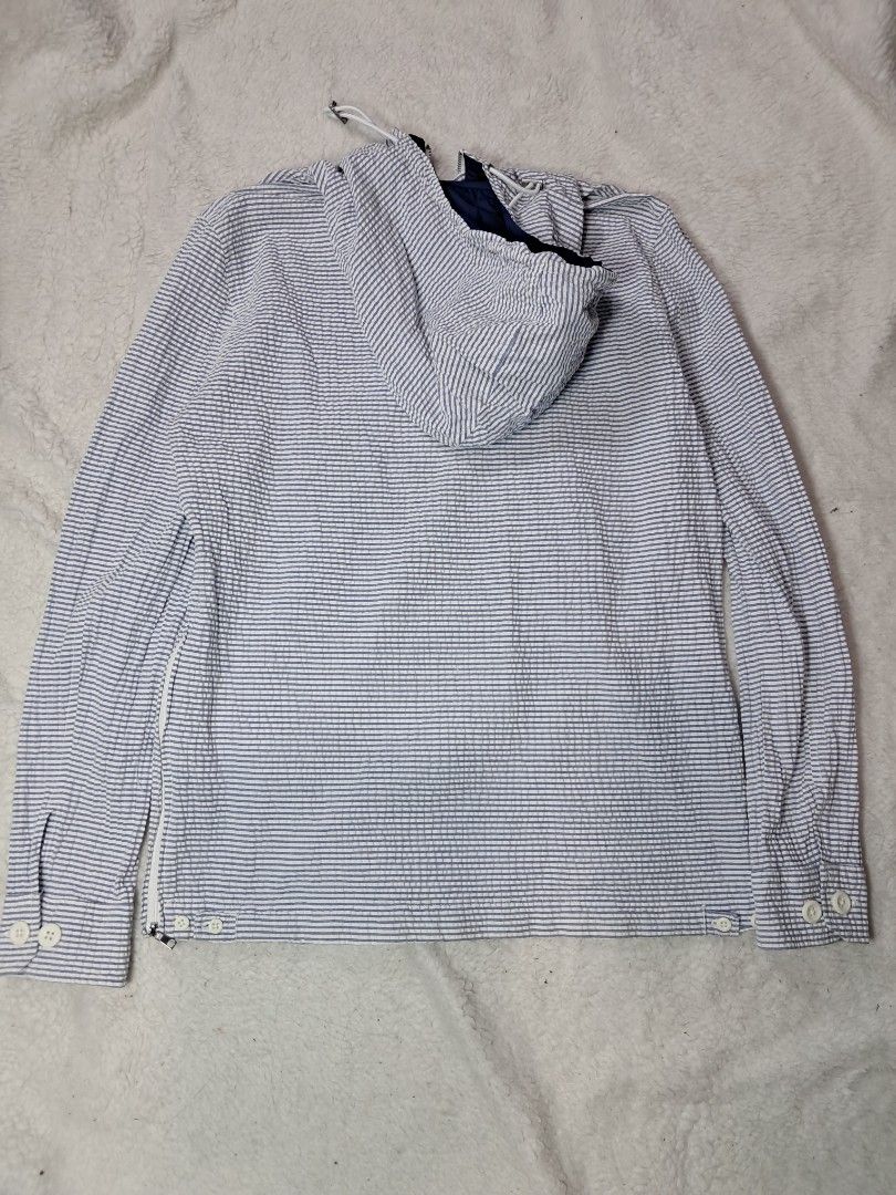 Zara anorak windbreaker jacket (Category: Coats, Jackets and Outerwear) located in Baguio. Submitted by mishmashfritz (Listing ID 1463196991, Image 2). Description: xs to s unisex, see dimes for reference,1 side zipper, adjustable hood, nylon lining sa hood, Blue and white striped seersucker fabric featuring puckered vertical stripes..