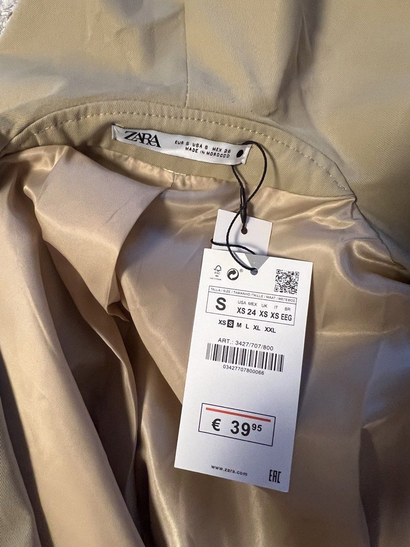 Zara Beige Cropped Wrap Jacket (Category: Coats, Jackets and Outerwear) located in Makati City. Submitted by warm.abc123 (Listing ID 1463253513, Image 2). Description: - Zara cropped jacket - Color: Beige - Size: S - Material: Polyester with satin lining - Design: Unique wrap style with statement sleeves - Versatile: Great for dressing up or down - Condition: Brand new with original tags attached, -never worn, hard to let go but impulsively bough