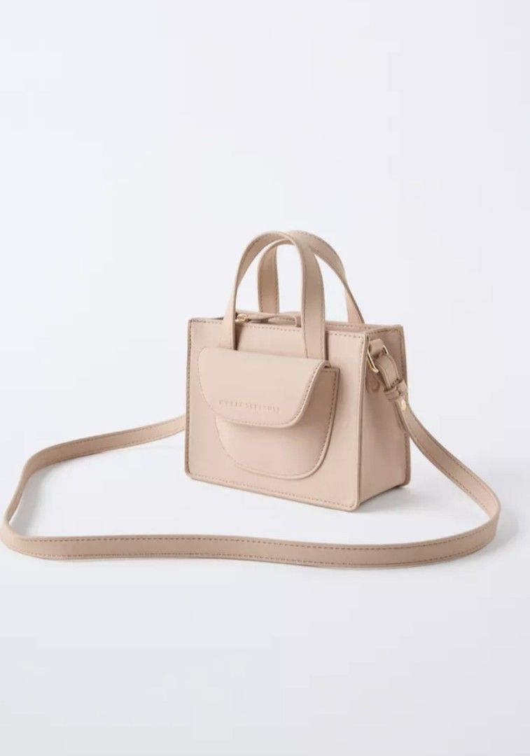 Zara mini crossbody bag (Category: Cross-body Bags) located in Manila. Submitted by mommynurse (Listing ID 1463129430, Image 1). Description: Neutral crossbody bag Zip closure Front zip pocket Shoulder strap Height x Length x Width 12 x 17 x 7 cm. / 4.7 x 6.6 x 2.7″ ( 1st and 2nd photo for reference only ).