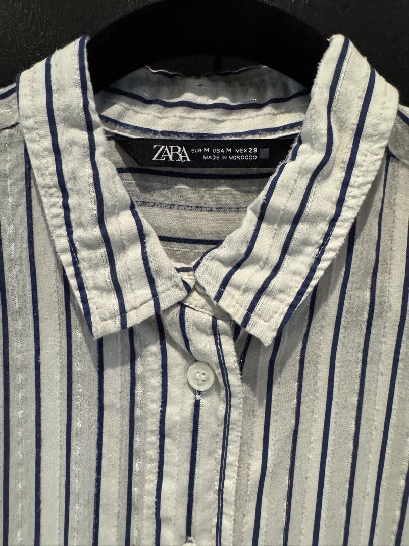 Zara Striped Button-Up Shirt (Category: Shirts) located in Mandaluyong City. Submitted by marshy (Listing ID 1463235921, Image 2). Description: White with navy blue and silver pinstripes .