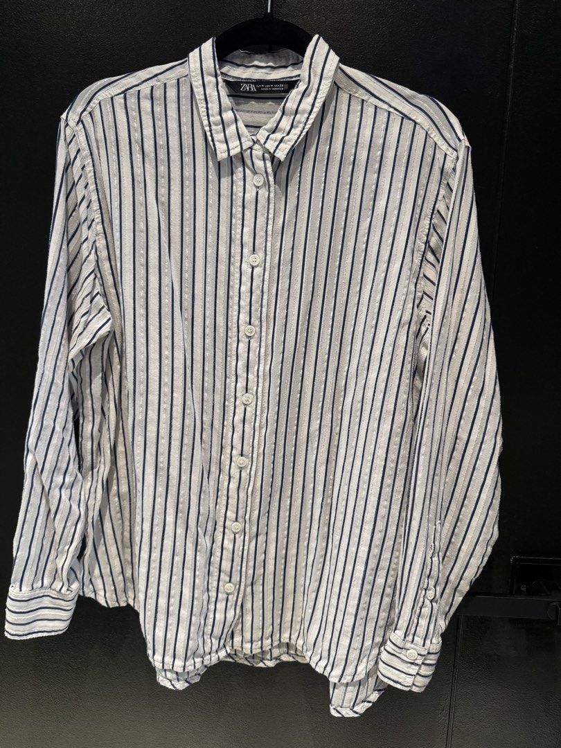 Zara Striped Button-Up Shirt (Category: Shirts) located in Mandaluyong City. Submitted by marshy (Listing ID 1463235921, Image 1). Description: White with navy blue and silver pinstripes .