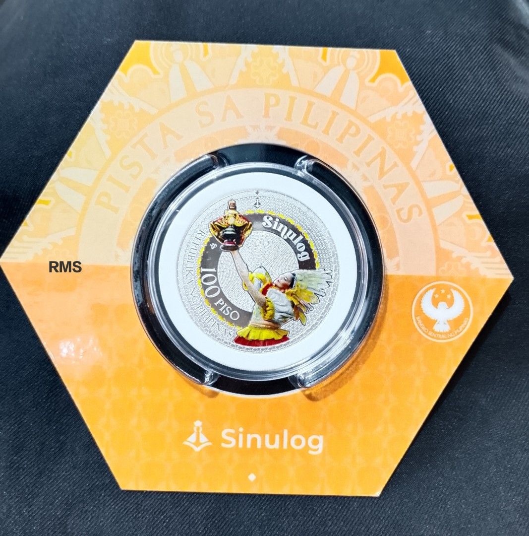 100-piso Sinulog Festival Coin (Category: Announcements) located in Quezon City. Submitted by coinsandbanknotes (Listing ID 1463393621, Image 1). Description: Product Specifications: Denomination: ₱ 100 Material: 99.9% silver Weight: 31.1 grams (1 troy ounce) Diameter: 38.6 millimeters.