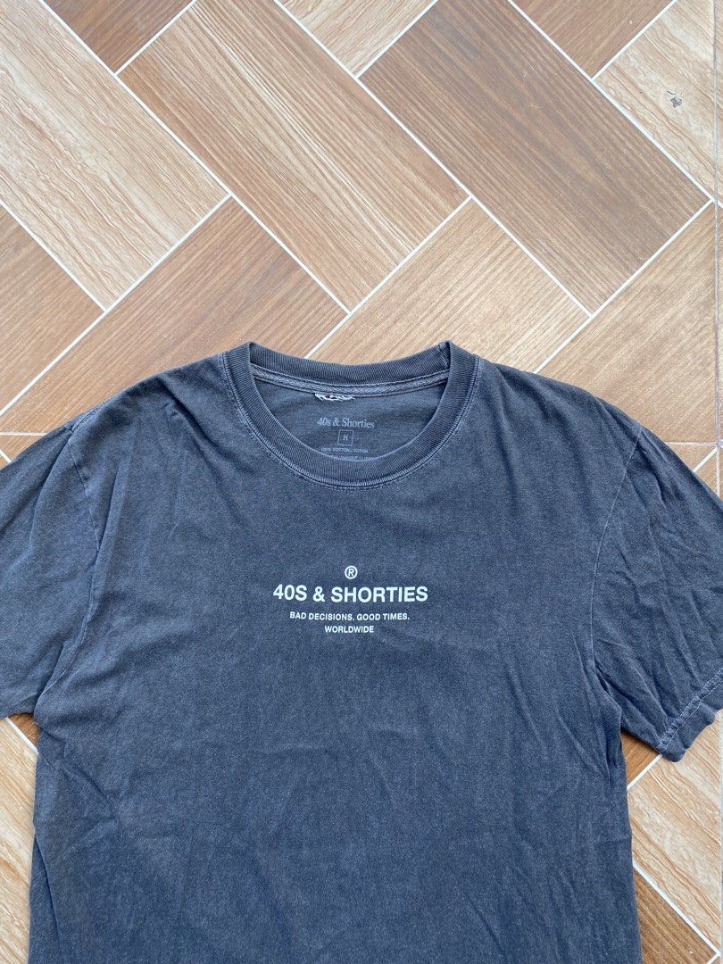 40s & Shorties T-Shirt Size M (Category: Tshirts & Polo Shirts ) located in Davao. Submitted by thirdy.pfp (Listing ID 1463417834, Image 2). Description: 40s & Shorties Charcoal Black tee Medium 20 width 28 length Excellent condition 9/10 350 - Grey 40s & Shorties T-shirt - Size: Medium (M) - Material: 100% Cotton - Design: Features 'Bad Decisions. Good Times. Worldwide.' slogan on front and back - Style: Ideal for casual wear.