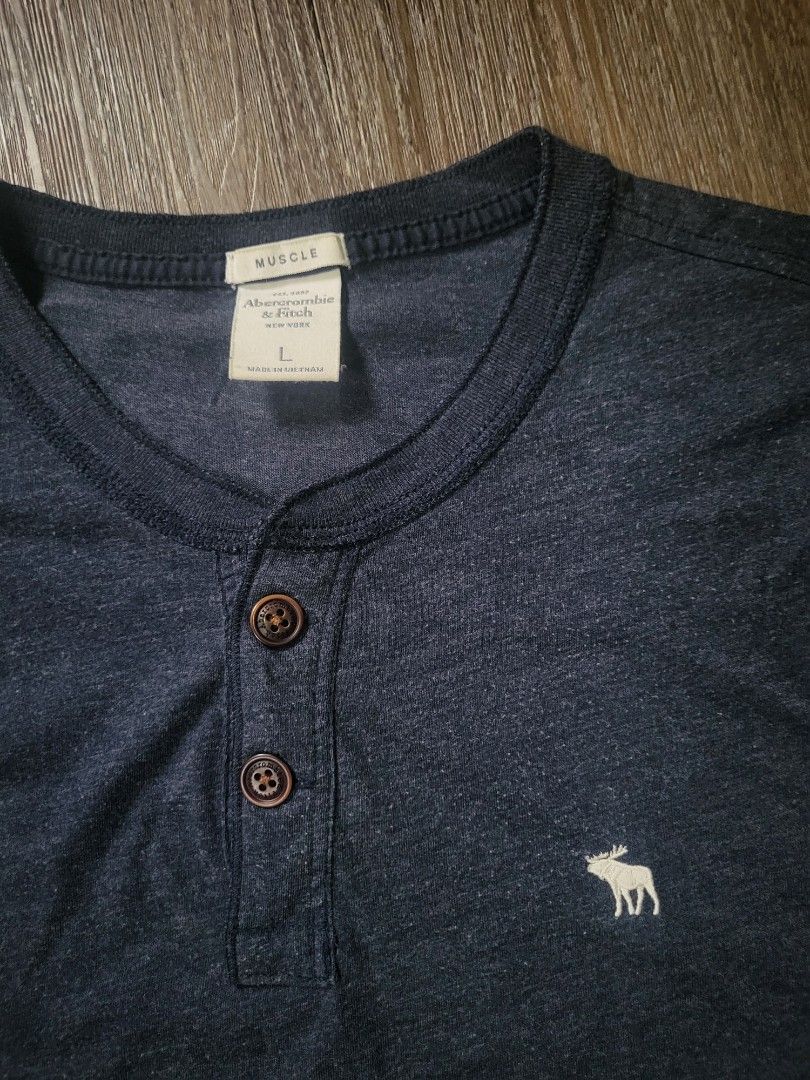 Abercrombie & Fitch Henley (Category: Tshirts & Polo Shirts ) located in Quezon City. Submitted by w_shawnyyy (Listing ID 1463381330, Image 2). Description: Abercrombie & Fitch Henley - Navy Blue - No issues, Very good condition - Not Thrifted, personal clothes Length- 29in Chest- 21in Location: Near SM Fairview Shipping: Lalamove, Jnt (buyer shoulders sf) .