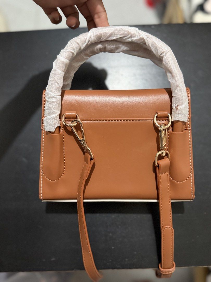 ACE FREE Two-Tone Top Handle Bag (Category: Tote Bags) located in Caloocan City. Submitted by rohllee (Listing ID 1463551871, Image 2). Description: - Stylish two-tone design (brown & off-white) - Versatile carrying options: top handle or detachable shoulder strap - Elegant gold hardware accents - Convenient interior pocket - Comes with a protective dust bag - Ideal for daily use.