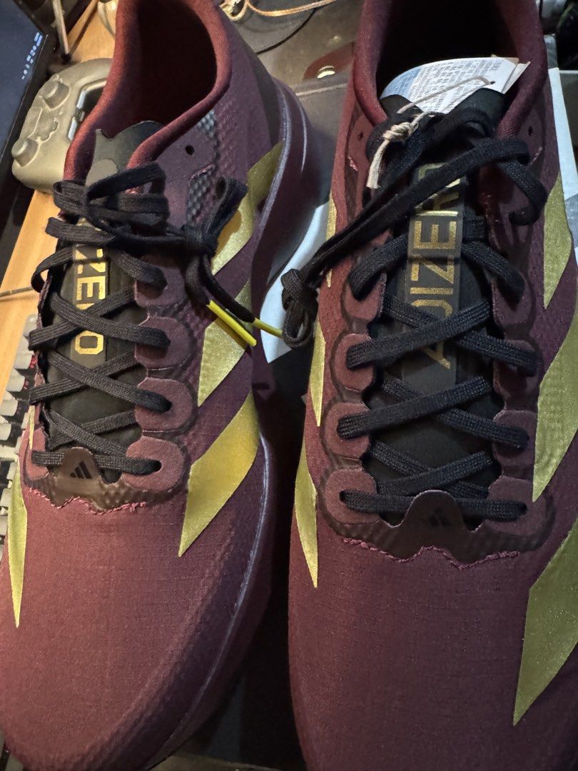 Adidas Adizero Evo SL Woven (Category: Sneakers) located in Davao. Submitted by midnightwolf07 (Listing ID 1463425928, Image 3). Description: - Maroon and gold Adidas Adizero running shoes - Lightweight design for speed - Perfect for races and training - Features black laces and gold Adidas stripes.