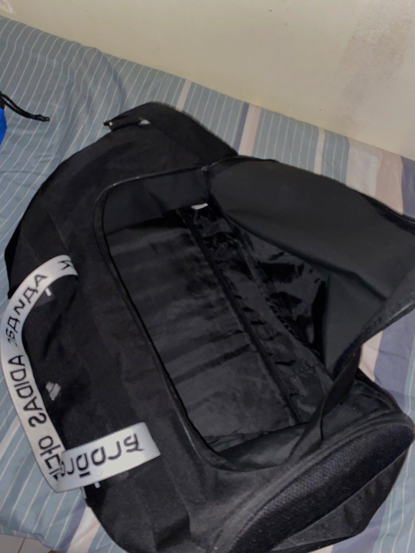 Adidas Black Duffel Bag with White Logo Strap (Category: Backpacks) located in Pasay City. Submitted by fastforest_312e97 (Listing ID 1463400279, Image 2). Description: - Black Adidas duffel bag - Main compartment for ample storage - Inner zip pocket for essentials - Adjustable strap with repeating Adidas logo - Ideal for gym sessions or short trips - Clean inside and out, ready for its new owner.