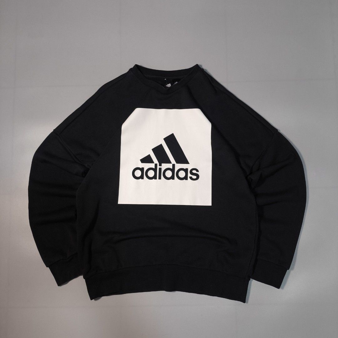 Adidas Black Sweatshirt with White Box Logo (Category: Coats, Jackets and Outerwear) located in Manila. Submitted by andreidemi19694 (Listing ID 1463385325, Image 1). Description: - Classic black Adidas sweatshirt - Features iconic white box logo with three stripes and Adidas text - Made from a comfortable fabric blend - Ideal for casual wear or layering - Tagged size M - Please check photos for detailed condition.