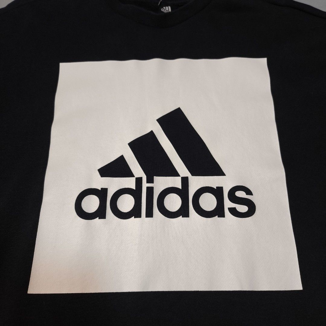 Adidas Black Sweatshirt with White Box Logo (Category: Coats, Jackets and Outerwear) located in Manila. Submitted by andreidemi19694 (Listing ID 1463385325, Image 3). Description: - Classic black Adidas sweatshirt - Features iconic white box logo with three stripes and Adidas text - Made from a comfortable fabric blend - Ideal for casual wear or layering - Tagged size M - Please check photos for detailed condition.
