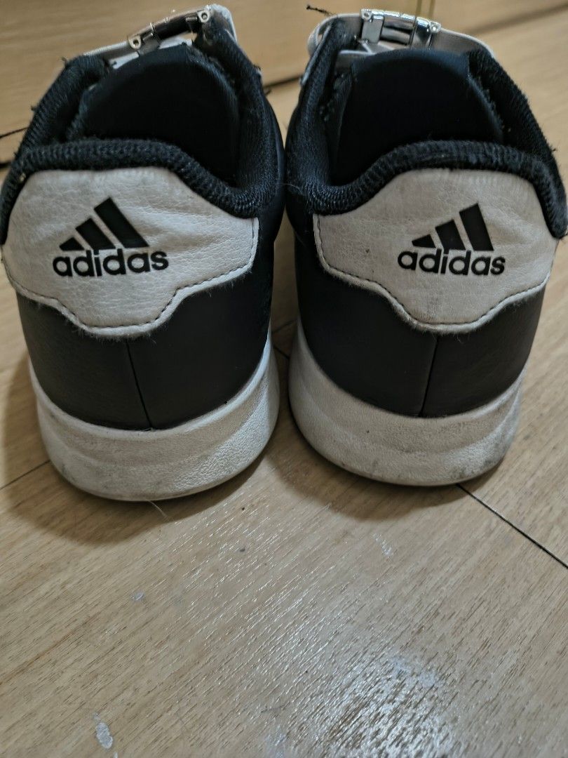 Adidas Black White Sneakers (Category: Sneakers) located in Manila. Submitted by hakunaematata (Listing ID 1463356966, Image 2). Description: - Black Adidas sneakers with iconic white stripes - Size: 6.5 UK - Made in Indonesia - Soles show some wear and dirt - Minor scuffing and wear on shoe edges - White laces - Ideal for casual wear.